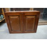 An Edwardian mahogany hanging cupboard, with a pair of fielded panel doors, 41.5cm high x 53.5cm