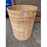 A contemporary wicker circular laundry basket.