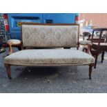 An Edwardian walnut and inlaid salon settee, 142cm wide.