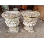 A pair of reconstituted garden urns, (a.f.), 48cm high.
