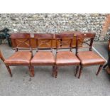 A set of four mahogany and line inlaid dining chairs.