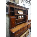 A George III oak and mahogany crossbanded dresser and rack, 176cm wide.