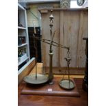 An antique set of Avery brass and mahogany balance scales, 66.5cm high, (incomplete).