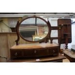 An early 19th century mahogany and boxwood strung bowfront toilet mirror, 51.5cm wide.