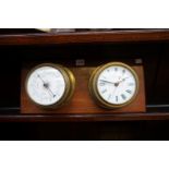 A brass clock and barometer set, on mahogany plaque, 49.5 x 22cm.