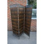 A bamboo and metal three fold screen, 81.5cm high x 143cm wide.