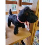 A vintage black mohair Terrier, straw filled with glass eyes, 26cm long.