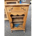 An antique pine side cabinet.