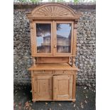 A Victorian carved pine bookcase cabinet, 110cm wide x 49cm deep x 215cm high.