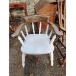 A white painted captain's style armchair.
