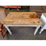 An antique pine kitchen table, having one drawer and white painted legs, 120cm wide x 83cm deep x