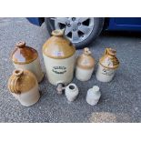 Seven old stoneware bottles.