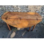 An antique pine dropleaf table, 136cm wide x 70cm high.