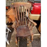 An antique comb back kitchen chair.