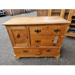 A Victorian pine chest of drawers, with one cupboard door, 96.5cm wide x 46.5cm deep x 76.5cm high.