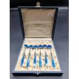 A cased set of six Norwegian silver gilt and blue guilloche enamel coffee spoons, the case inscribed