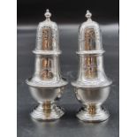 A pair of late Victorian silver pepperettes, by Charles Stuart Harris, London 1901, 166g, 12cm high.