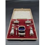 A cased silver cruet set, by Walker & Hall, Birmingham 1962; together with three condiment spoons,