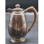 An Arts & Crafts hammered silver hot water pot, by Liberty & Co, Birmingham 1910, no.5813, 234g,