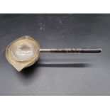 A Danish hammered silver tea strainer, by Johannes Siggaard, circa 1933, 67g all in, 18cm long.