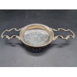 A continental white metal oversized twin handled strainer, 113g, 22cm wide.