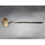 A 19th century Danish silver gilt ladle, marks rubbed, with ebony handle, 44cm long.