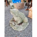 A reconstituted stone frog ornament.