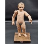 An interesting Continental carved and painted wood figure of a boy, with glass inset eyes and