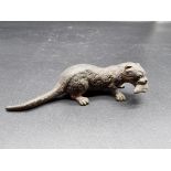 A cold painted bronze otter and fish figure group, in the manner of Franz Bergman, 9.5cm long.