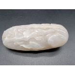 A Chinese carved white jade pebble, 11cm wide.