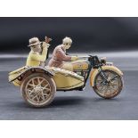 A vintage tinplate clockwork motorcycle and sidecar figure group, 17cm long.