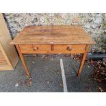 An old pine two drawer side table, 92.5cm wide x 60cm deep x 65cm high.