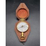 A good 19th century mahogany cased gilt brass pocket compass, with enamel dial, 5.2cm diameter.