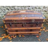 A vintage wood bound dome topped trunk.