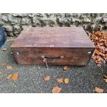 A wood box containing a quantity of old tools.