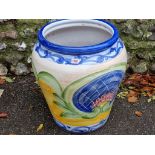 A large painted terracotta urn, 51cm high x 44cm wide; together with another blue glazed urn and