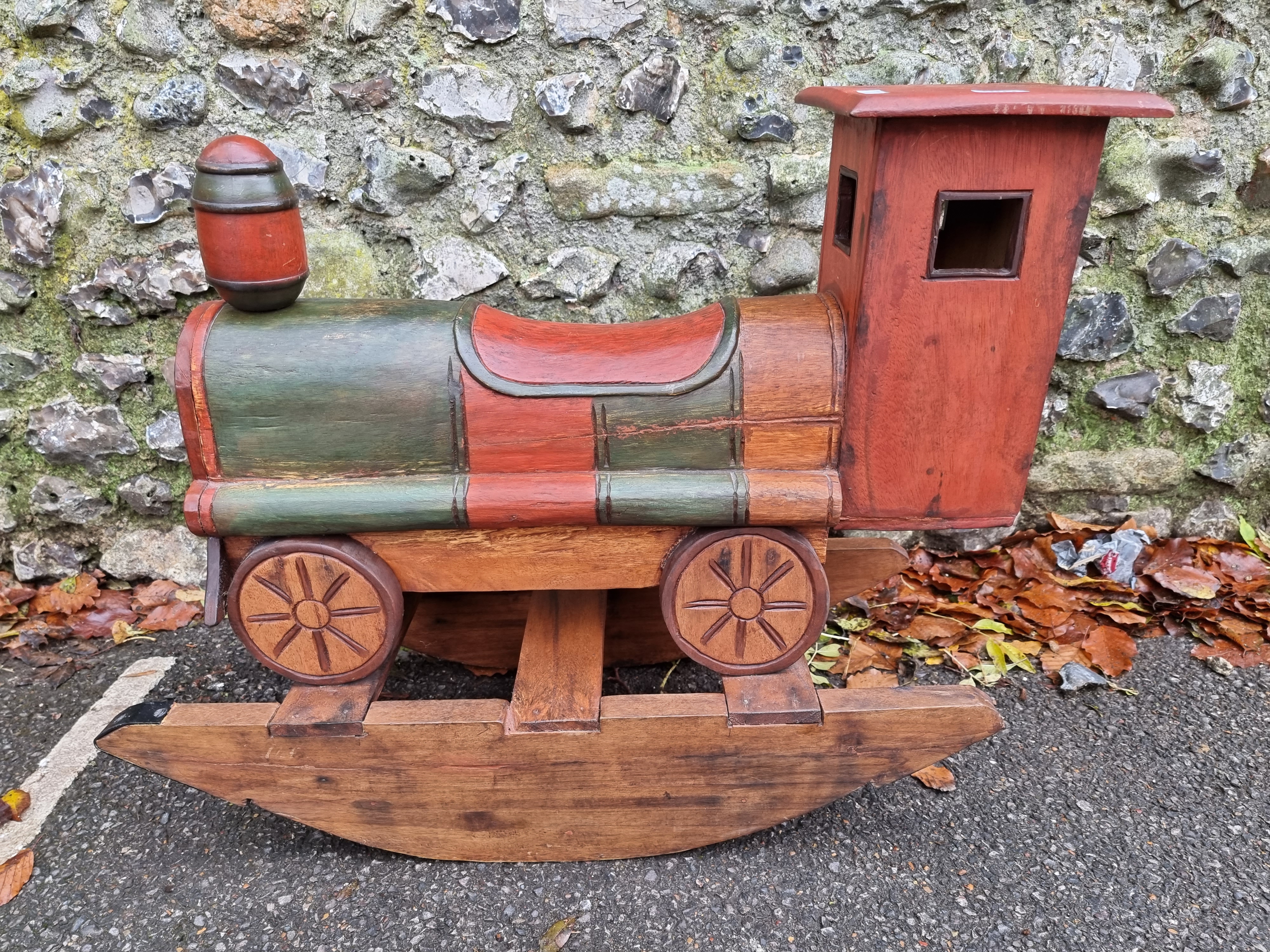 A child's painted wood rocking train, 80cm wide.