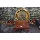 An eastern brass tray; together with a carved oriental footstool, with reversible top.