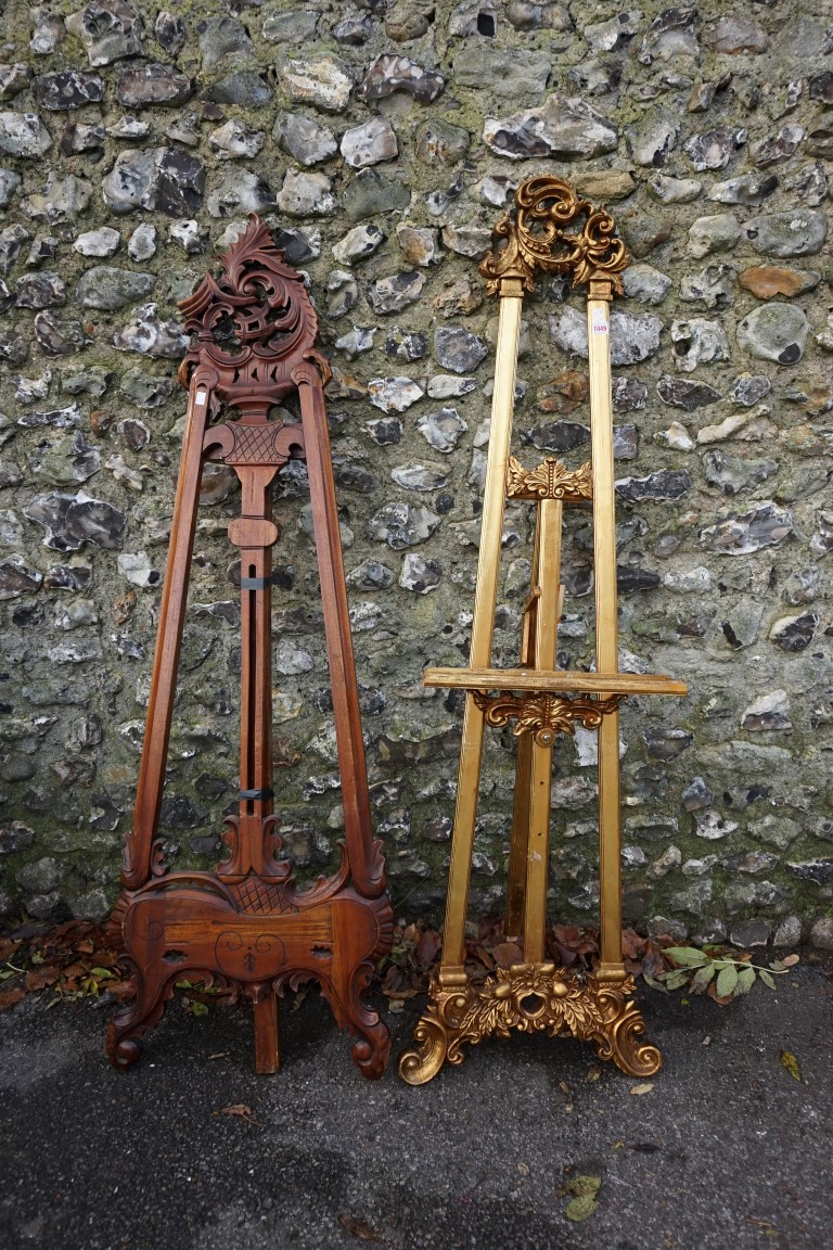 A gilt wood easel, 174cm; together with another carved example, 168cm high. (2)