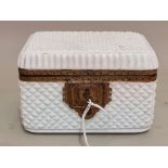 An antique French opaque cut white glass casket, 16cm wide, with key.