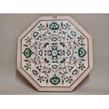 A marble and pietra dura octagonal panel, decorated with malachite and mother-of-pearl, 31cm