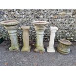 A small collection of composition stone pedestals and bird baths, (chips).
