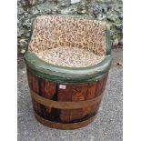 An oak and copper barrel chair.