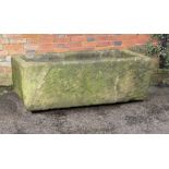 † A rectangular carved sandstone trough