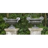 A pair of unusual carved green granite urns