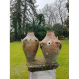 A pair of unusual offset double handled terracotta pots