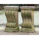 † A pair of carved sandstone wall consoles