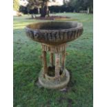 An unusual faux bois composition stone bowl on stand