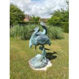 A bronze fountain group of three cranes