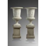 A pair of carved white marble urns